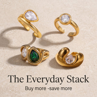 The Everyday Stack, four gold rings with clear and green stones