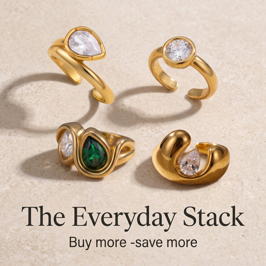 The Everyday Stack, four gold rings with clear and green stones