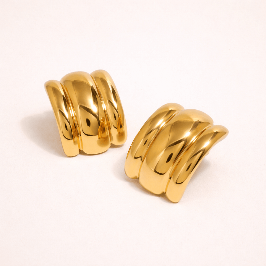 Pair of gold hoop earrings on a white background
